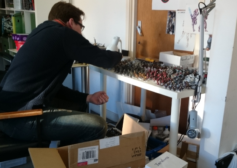 Stew sorts a mountain of painted miniatures.